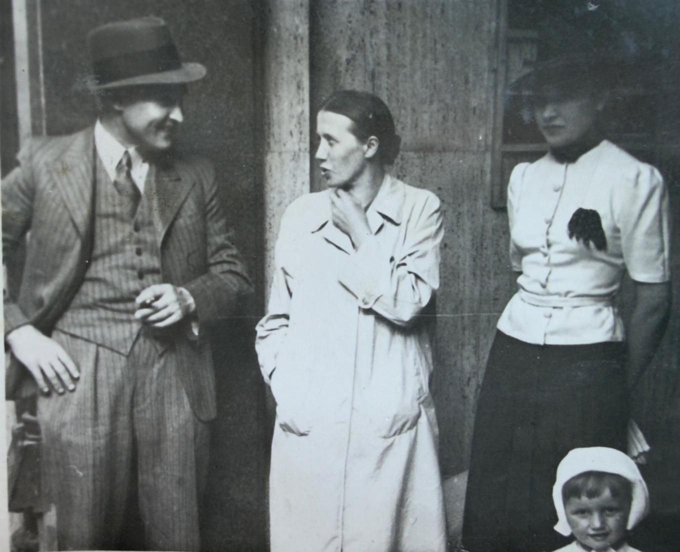 Natalia (centre) at the entrance to the building — behind her the characteristic stone of the hall facings. From a private collection.