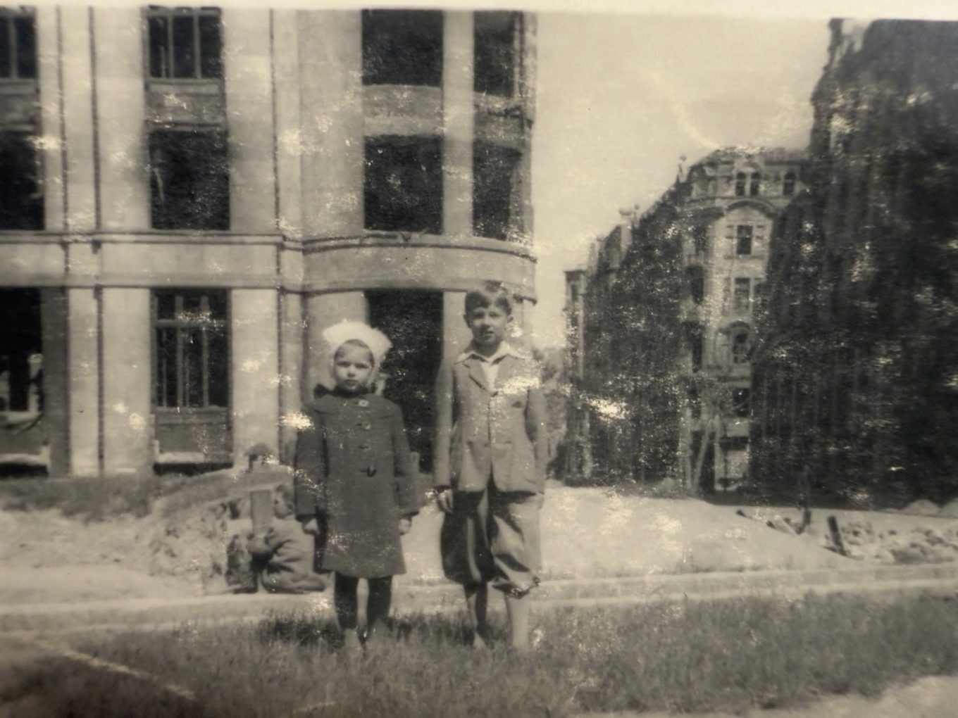 Tadeusz and Irena just after the war — among the ruins and rubble of rebuilding Warsaw. In the background the same glazed corner by which, a few years later, the teenage Irena would be photographed. From a private collection.